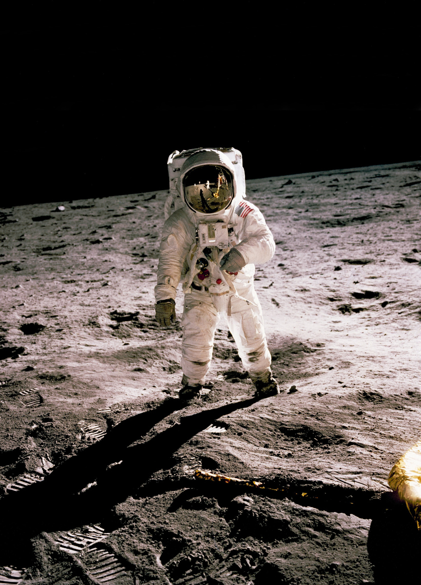 Buzz Aldrin in full astronaut uniform walking on the moon