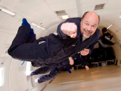 A man experience weightlessness aboard ZeroG aircraft